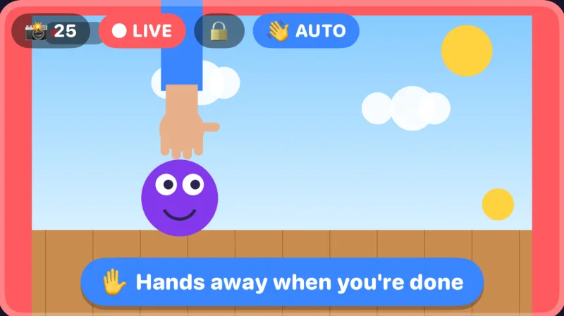 Auto Snap in the app: a hand is still holding the purple puppet, and the app says “Hands away when you're done”